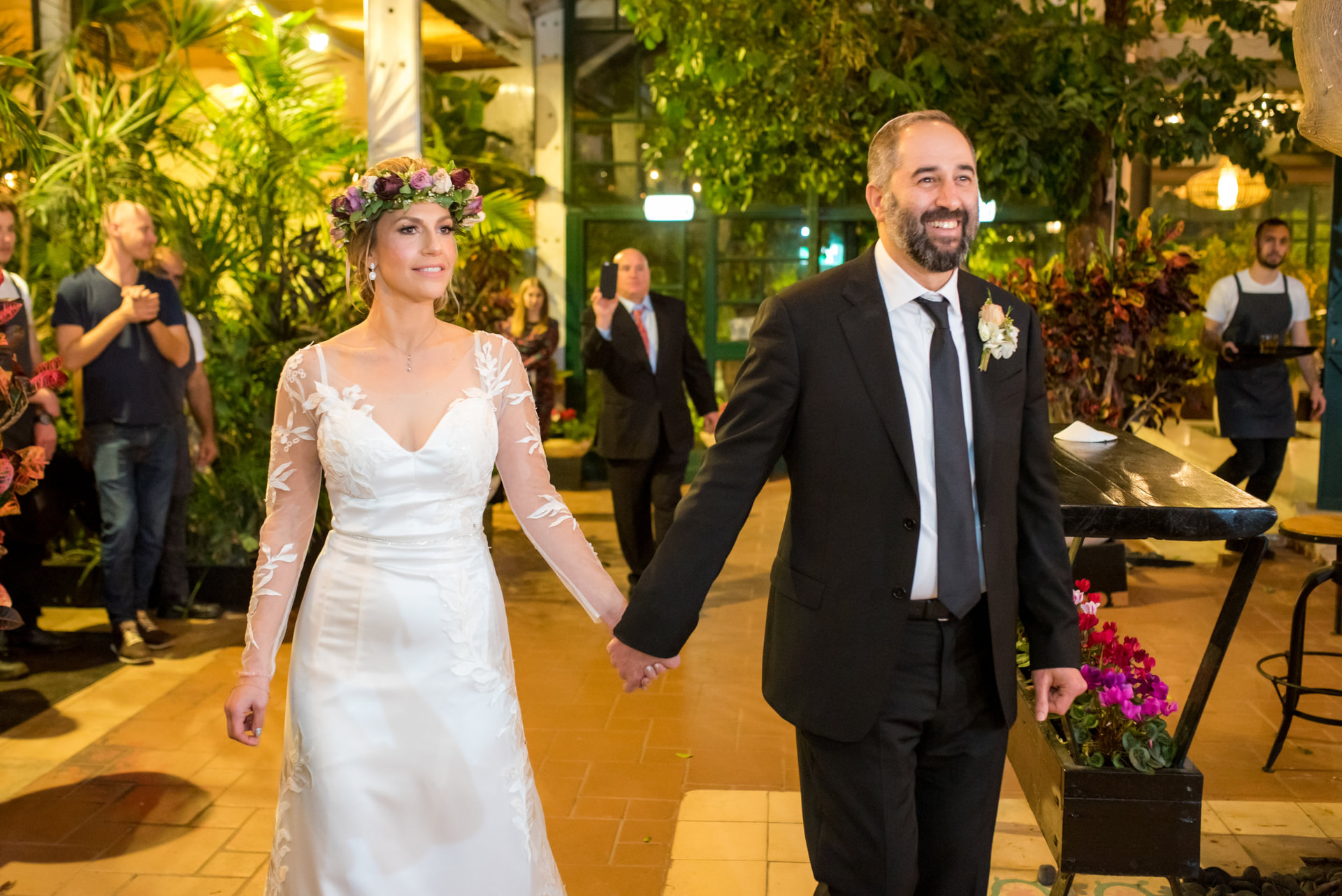Sarah and Doron walking hand in hand on their wedding day