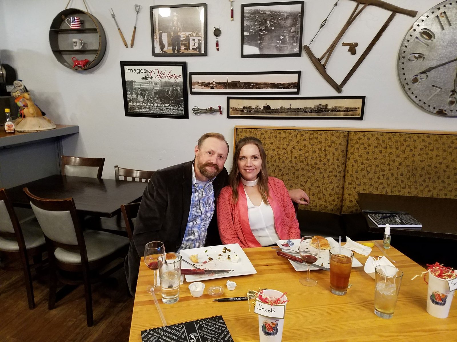 Sarah and Jacob seated together at a restaurant table, smiling
