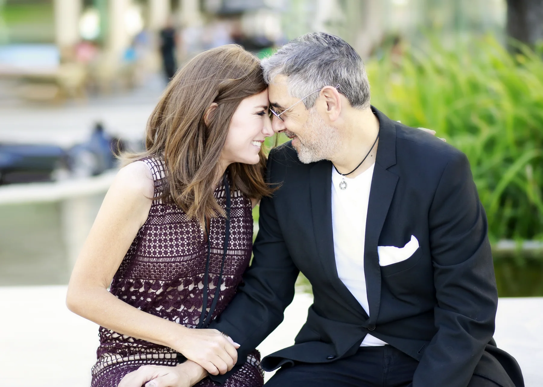 Bari and Michael smiling with foreheads touching outdoors