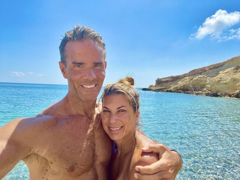 Lori and Chris smiling in a seaside selfie